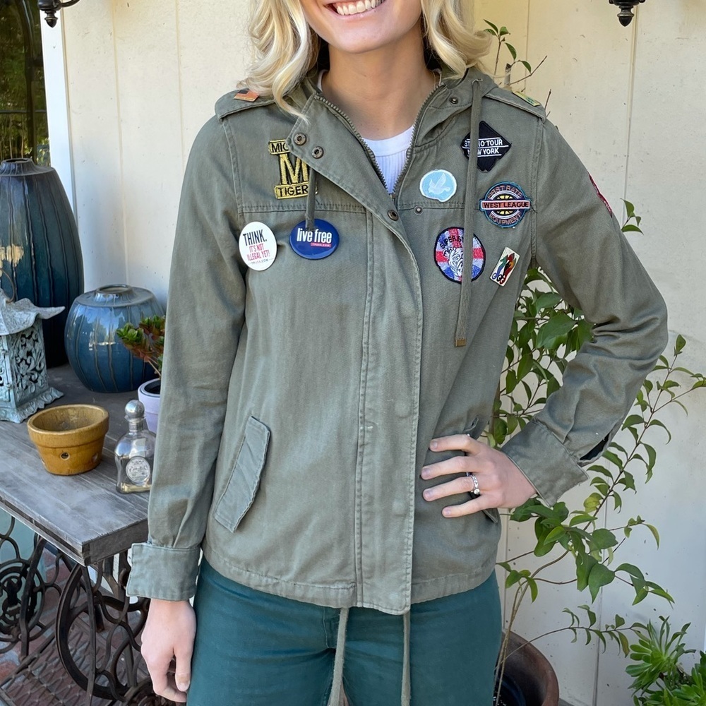 Army jacket with pins and patches